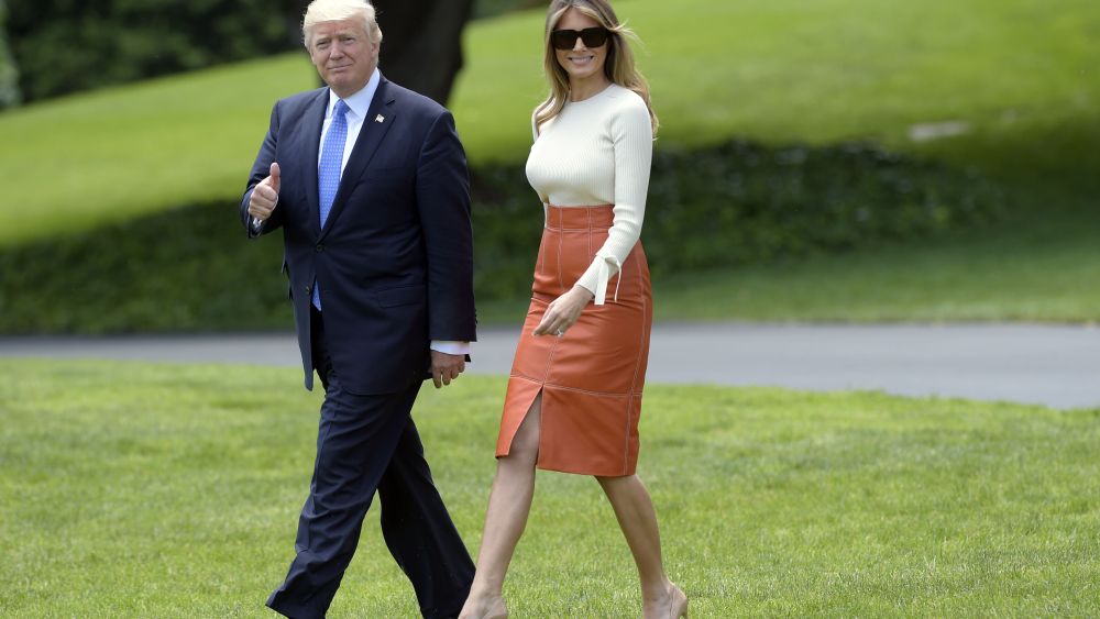 President Donald Trump and first lady Melania Trump walk across the South Lawn of the White House in Washington.