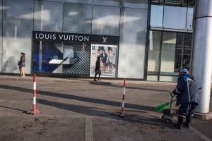 Women walk past a sign for Louis Vuitton in Ulaanbaatar, Mongolia on March 20, 2017. Photographer: Taylor Weidman