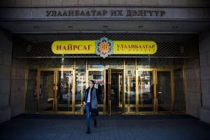 A Mongolian woman exits the Ulaanbaatar Department Store in Ulaanbaatar, Mongolia on March 19, 2017. Photographer: Taylor Weidman
