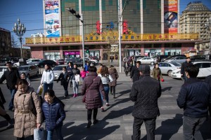 Mongolians cross a street near the State Department Store in Ulaanbaatar, Mongolia on March 19, 2017. Photographer: Taylor Weidman