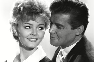 'The Saint' TV - 1962 - The Pearls of Peace -Erica Rogers, Roger Moore.'The Saint' TV Series. - 1962The Saint is visited by Joss Hendry, whose fiancee, Brad, disappeared in Mexico, some years earlier, trying to search for the pearls of San Domingo. She has recently heard from Brad to say that he has the pearls and she wants the Saint to go and get them for her. When the Saint eventually meets Brad he finds he has been blinded after a fight and is dependent on the plain but adoring Consuelo, who feeds his delusion that he has actually located valuable pearls. The Saint decides he will help the couple at the expense of the greedy Joss.