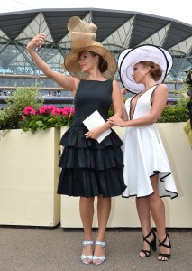 Racegoers take selfies in front of the main stand on Ladies Day.Royal Ascot, Day Three, Ladies Day.