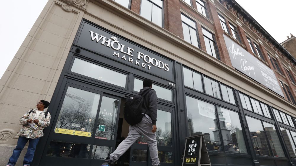 Copyright 2017 The Associated Press. All rights reserved. This material may not be published, broadcast, rewritten or redistributed without permission.Mandatory Credit: Photo by Julio Cortez/AP/REX/Shutterstock (8450710f)A pedestrian walks in front of the entrance to the Whole Foods supermarket during its grand opening, in Newark, N.J. Whole Foods anchors the renovated Hahne's building, which opened a month earlier after being closed for 30 yearsSupermarket, Newark, USA - 01 Mar 2017