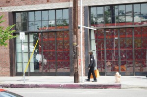 A shopper coming out of the Louis Vuitton x Supreme Los Angeles pop-up