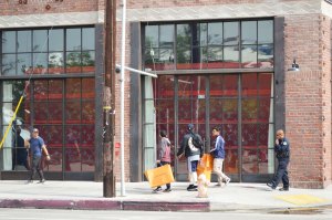 Shoppers coming out of the Louis Vuitton x Supreme Los Angeles pop-up