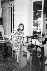 Outtake; Portrait of French actress Jeanne Moreau wearing a loose chemisey dress of orange silk with black scroll print and no make-up during an interview with Women's Wear Daily, accompanied by a bouncing blue-fox color, small sized poodle named Voyou (gutter-snipe) in Paris, France, circa August 1964.

Article title: "La Moreau"
