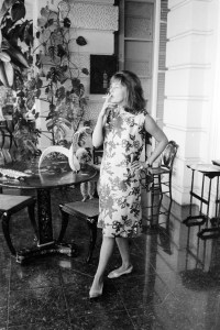 Outtake; Portrait of French actress Jeanne Moreau wearing a loose chemisey dress of orange silk with black scroll print and no make-up during an interview with Women's Wear Daily in Paris, France, circa August 1964.Article title: "La Moreau"