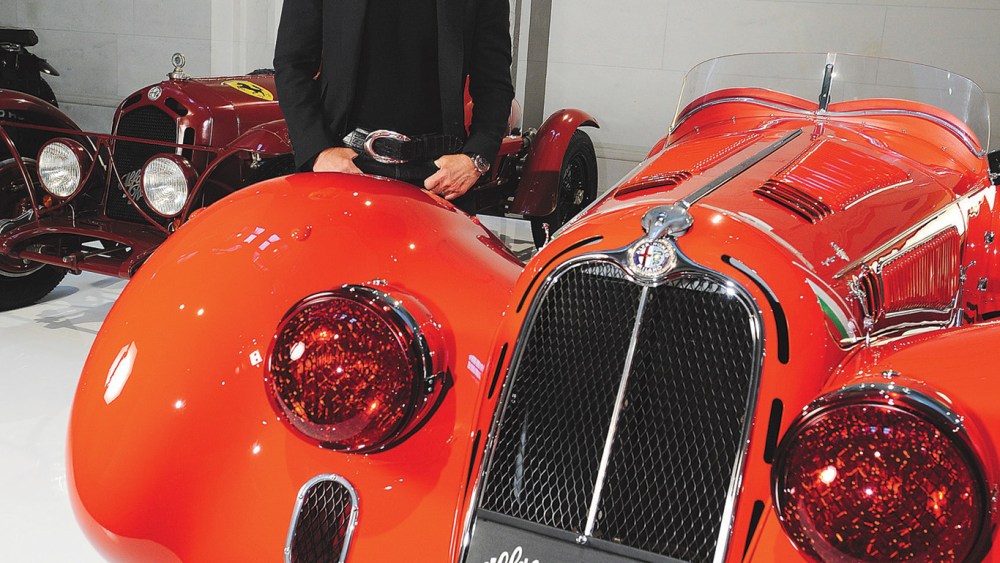 Fashion designer Ralph Lauren standing next to one of his Alfa Romeros, one of the cars from his collection on display at Les Arts Decoratifs.