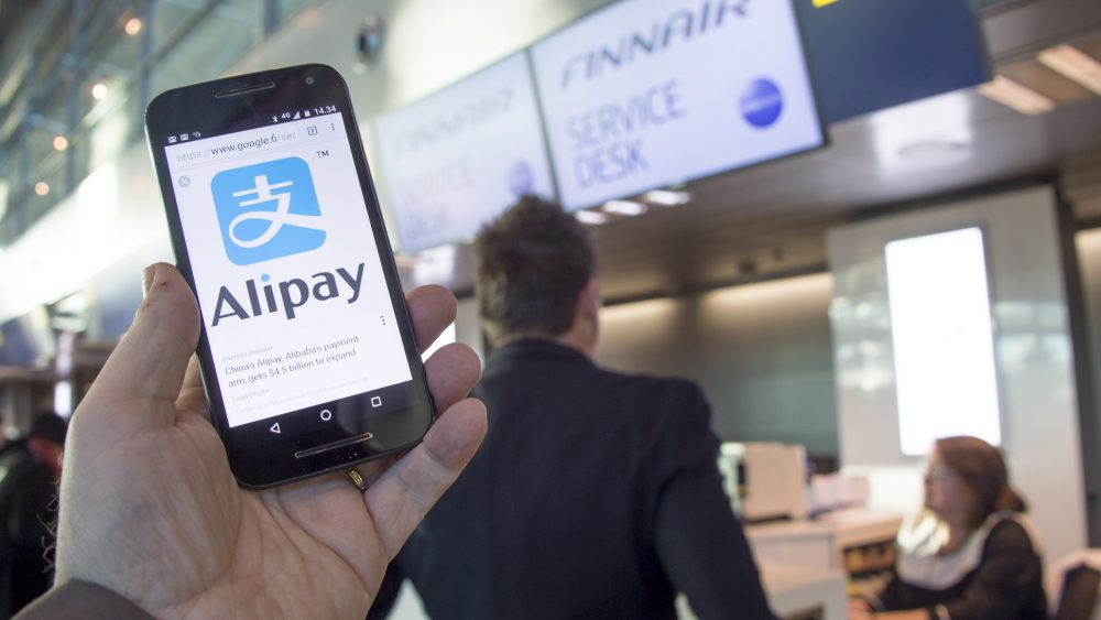 An Alipay-app on a smartphone screen and Finnair logos at the Helsinki airport, Finland, 27 January 2017. Finnish flag carrier Finnair said it will launch Alipay as an official method of in-flight payments for customers travelling on carrier's Asian route between Helsinki and Shanghai. Alipay is the mobile payment platform of Chinese Ant Financial. Finnair is the first airline to accept payments via Alipay.Finnair accepts Alipay for payments on passenger planes on its Asian routes, Vantaa, Finland - 27 Jan 2017