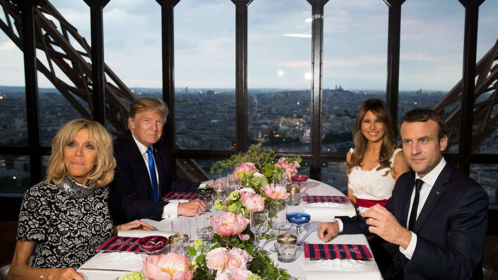President Donald Trump, first lady Melania Trump, French President Emmanuel Macron his wife Brigitte Macron, sit for dinner at the Jules Verne Restaurant on the Eiffel Tower in Paris, Thursday, July 13, 2017. (AP Photo/Carolyn Kaster)