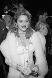 Madonna in lace sleeves, necklaces and fur wrap at the premier of her movie "Desperately Seeking Susan" in Los Angeles