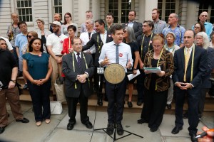 Garment Center Steering Committee supporters speak out on the steps of City Hall.