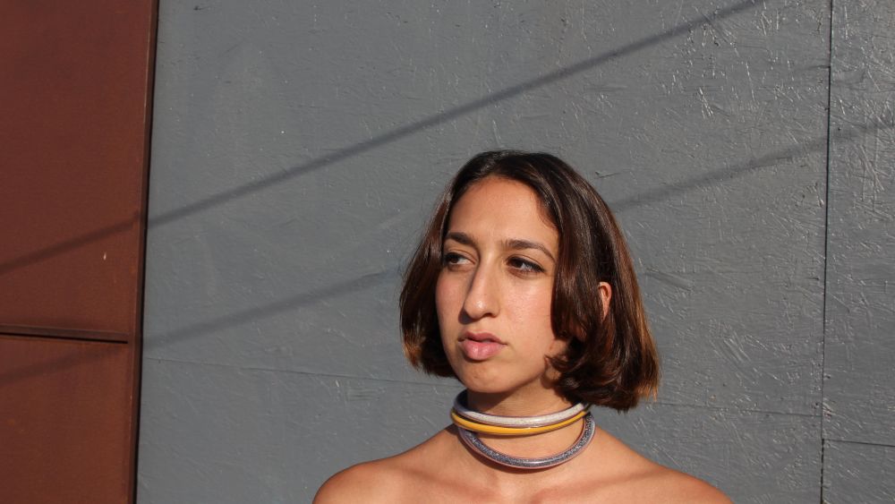 Artist Ida Badal in necklaces of her design.