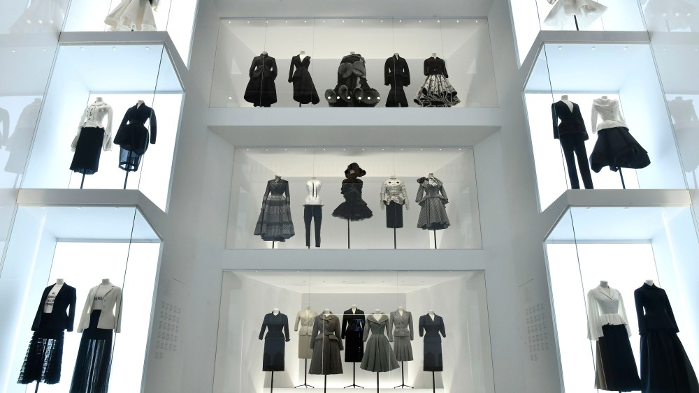 Vintage Dior designs sit alongside outfits by contemporary brands like Thom Browne, Comme des Garçons and Givenchy in the Dior exhibition at Les Arts Décoratifs.