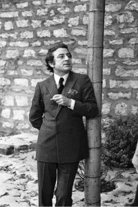 Pierre Berg  talking in the garden of Yves Saint Laurent's Paris home.