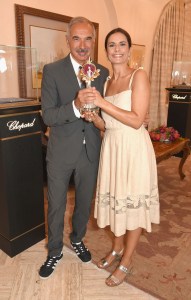 VENICE, ITALY - SEPTEMBER 01:  Carlo Capasa and Livia Firth pose with the Green Carpet Fashion Award as they attend an intimate lunch to announce Chopard as partner for The Green Carpet Fashion Awards at Hotel Cipriani on September 1, 2017 in Venice, Italy.  (Photo by David M. Benett/Getty Images for Eco-Age)