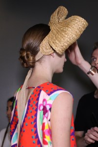 Jay Braff for Aveda created a braided bun that looked simple but took a lot of steps to create. Models' hair was flat on top so headpieces could be incorporated into the looks. "I like how intelligent it is," Braff noted. "It's very simple, but it's almost complex to do because it's so simple." The overall look was inspired by composer Xavier Cugat and photographer Maria Svarbova's swimming pool series.