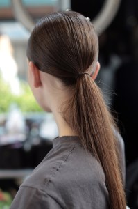 “The clothes are a mix of very sophisticated but sporty, so we decided to have a ponytail which sits exactly where the hole of a baseball cap would be,” said Odile Gilbert, lead hairstylist for TRESemmé. “We left two pieces of hair hanging out in the front because the girl is active.” Most girls had ponytails — five actually had baseball caps to loop them through — but girls with curly and short hair were left alone. “The ponytail is really American,” said Gilbert. “You don’t see it anywhere else.” Gilbert used TRESemmé Keratin Smooth Flatiron Smoothing Spray to smooth out strands before tying them up. 
