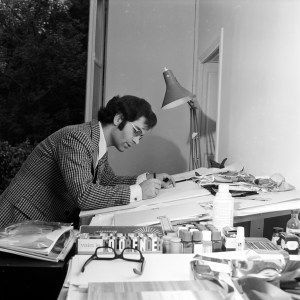 German fashion designer Karl Lagerfeld sketching at drawing table