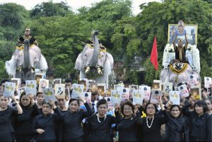 Elephants doused in powder to appear an auspicious white, stand to attention and trumpet at a ceremony in the ancient royal capital Ayutthaya, Thailand.