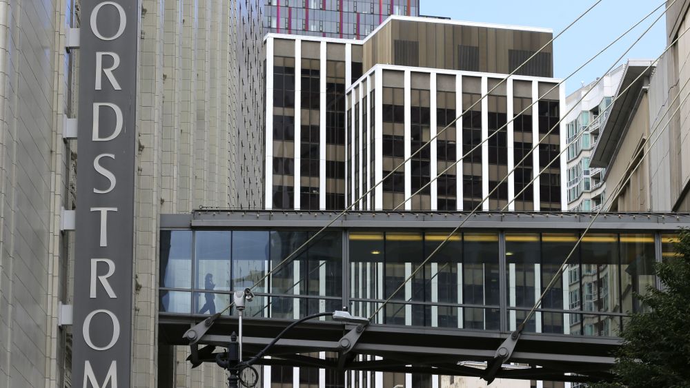 Shoppers walk though an elevated walkway at Nordstrom's flagship store in downtown Seattle. Nordstrom says it's temporarily halting an exploration into taking the company private. The retailer said that a group that includes several members of the Nordstrom family plans to resume looking into a possible deal after the holiday season endsNordstrom, Seattle, USA - 13 Sep 2017