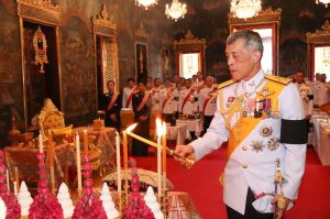 King Maha Vajiralongkorn Bodindradebayavarangkun lights candles at a religious temple ceremony on Oct. 16.
