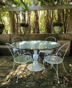 A section of the walled 'grey garden' which was imported from Spain. The table and chairs are original.
