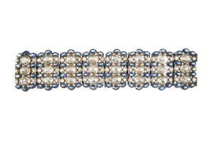 An eight panel bracelet featuring simulated sapphires and diamonds with sliding pin closure.  Worn by Lucille Ball in "Annabel Takes a Tour" (RKO Radio Pictures, 1938); Bette Davis in a 1930s studio publicity portrait; Ruth Donnelly in "Pillow to Post" (Warner Bros., 1945); and Maureen O'Hara in "Bagdad" (Universal, 1949).