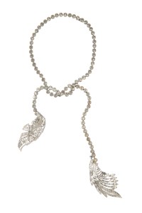 A simulated diamond crossover necklace suspending large Art Deco style dress clip brooches. Worn by Mae West in the final musical finale of "The Heat's On" (Columbia, 1943) and by Judy Garland in "Ziegfeld Follies" (MGM, 1946).
