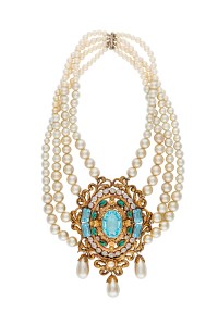 A graduated, four strand simulated pearl necklace centering on a gold plated filigree medallion set with simulated aquamarine, emeralds and diamonds with pearl drops.  Worn by Bette Davis in "The Virgin Queen" (20th Century Fox, 1955).