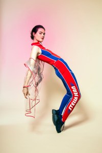 Stella Jean’s polyamide and elastane top and trousers and Anya Hindmarch’s PVC with grosgrain binding and an embellished collar coat. Stella McCartney sneakers.