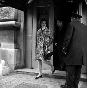 Jackie Kennedy leaving a Manhattan building wearing a leopard skin coat and white turtleneck