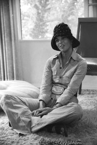 Portrait of actress Ali MacGraw wearing a belted purple safari pantsuit with navy floral bucket hat at a friend's home in Beverley Hills
The REAL MacGraw, Los Angeles