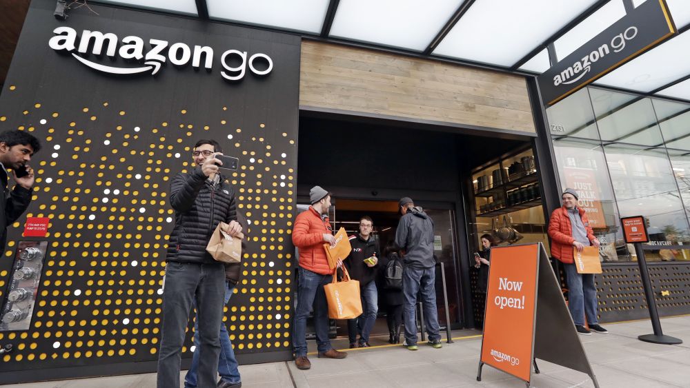 People stand outside an Amazon Go store, in Seattle. More than a year after it introduced the concept, Amazon opened its artificial intelligence-powered Amazon Go store in downtown Seattle on Monday. The store on the bottom floor of the company's Seattle headquarters allows shoppers to scan their smartphone with the Amazon Go app at a turnstile, pick out the items they want and leaveAmazon Go Store, Seattle, USA - 22 Jan 2018