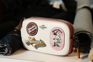 Minnie Mouse is fitted by Stuart Fevers for her custom Coach outfit.