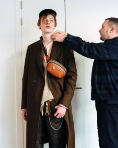 Kim Jones fitting a mode at the Louis Vuitton studio for a fall 2017 look.