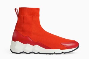Pierre Hardy unleashed his inner child for fall, drawing inspiration from “boys toys” including his childhood favorite rally racing game. “Anything sporty with clean lines. It’s a very masculine collection,” he said. Styles included a new take on the Comet sneaker with an exaggerated, Ferrari red sock boots and a new sneaker/dress shoe hybrid in neoprene and leather done in varsity colors.  Tote bags and wallets came in a print resembling the checkerboard flag waved on the finish line.