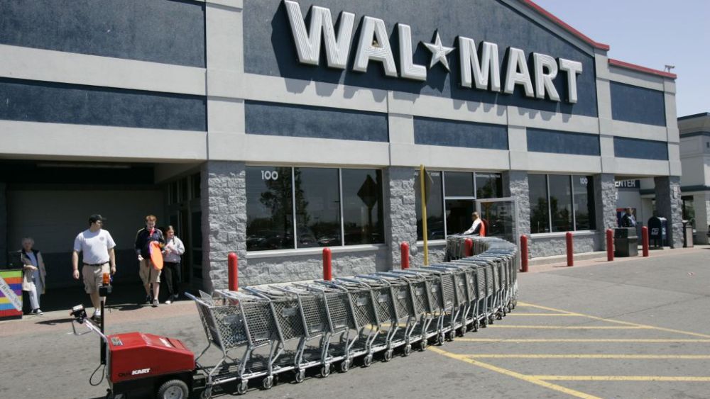 Customers leave Wal-Mart as a machine pushes shopping carts back to the store in Cheektowaga, N.Y. Wal-Mart Stores stores will be phasing out selling Amazon.com's Kindle tablet and e-readers, the world's largest retailer said Thursday, Sept. 20, 2012Wal-Mart Stores-Kindle, CHEEKTOWAGA, USA