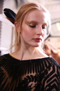 Christelle Cocquet took a cue from Zuhair MuradÕs spring couture collection, which had Native American influences with its embroideries and colors, such as red, black and gold. ÒHe didnÕt want us to do a classic makeup,Ó she explained. So instead, Cocquet created a look with a touch of gold starting from the outer top lids of modelsÕ eyes to their temples. For this, she used a metallic powder mixed with makeup remover. ÒItÕs like eye jewelry weÕve put on in gold,Ó Coquet said. Ñ Jennifer Weil