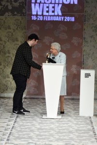 Queen Elizabeth presents Richard Quinn with the award