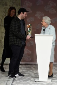 Queen Elizabeth presents Richard Quinn with the award