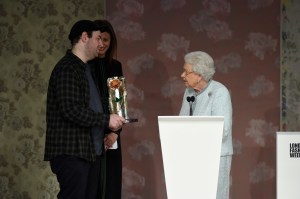 Queen Elizabeth presents Richard Quinn with the award