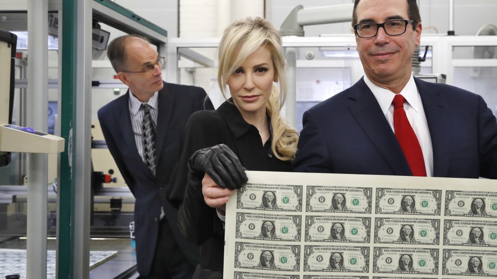 Steven Mnuchin, Louise Linton. Treasury Secretary Steven Mnuchin, right, and his wife Louise Linton, hold up a sheet of new $1 bills, the first currency notes bearing his and U.S. Treasurer Jovita Carranza's signatures, at the Bureau of Engraving and Printing in Washington. The Mnuchin-Carranza notes, which are a new series of 2017, 50-subject $1 notes, will be sent to the Federal Reserve to issue into circulationMnuchin Currency, Washington, USA - 15 Nov 2017
