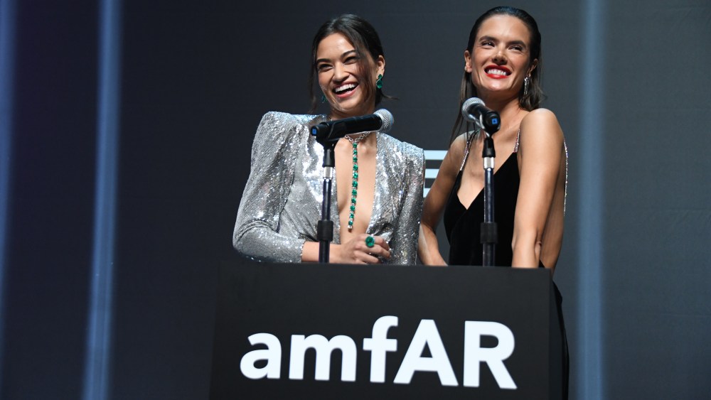 Shanina Shaik and Alessandra Ambrosio speak at the amfAR Hong Kong gala.