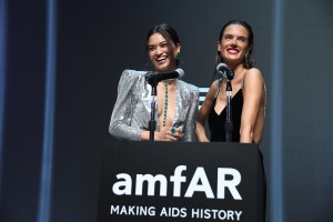 Shanina Shaik and Alessandra Ambrosio speak at the amfAR Hong Kong gala.