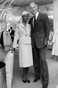 Fashion designer Hubert de Givenchy with a model wearing an outfit from his spring 1979 couture collection, his line-for-line Bergdorf Goodman copy - the seagreen gabardine SHAPED suit on mannequin Aria on March 1, 1979 in New York
