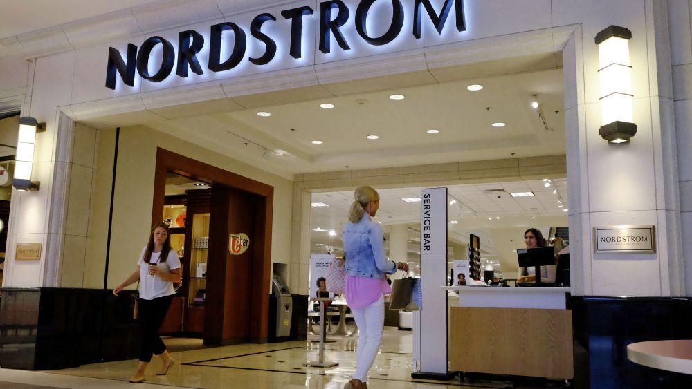 Shoppers leave and enter a Nordstrom store, in Indianapolis.