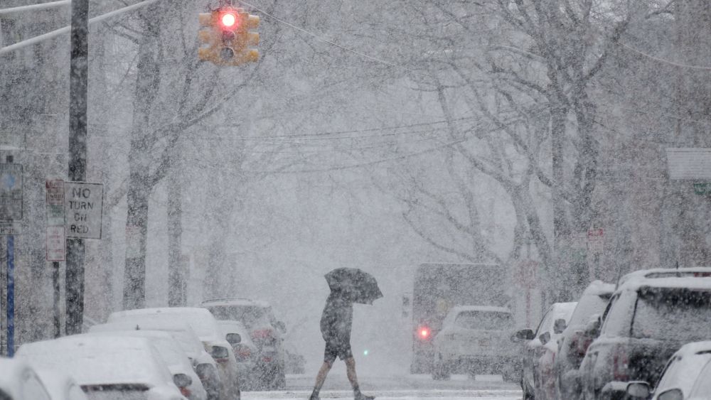 A man crosses the street through heavy snow in Hoboken, N.JNortheast Storm New Jersey, Hoboken, USA - 07 Mar 2018