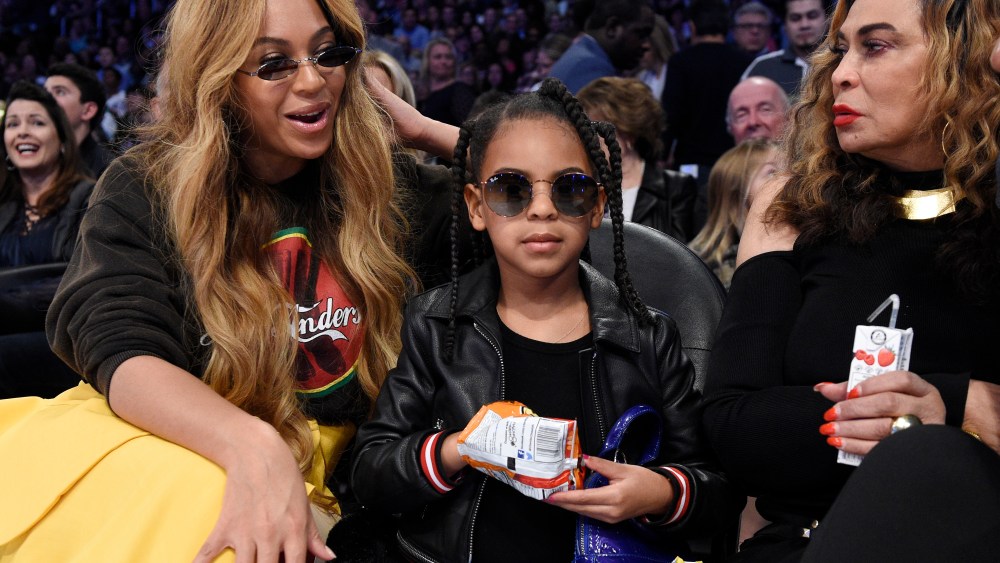 Singer Beyonce, left, sits with her daughter Blue Ivy Carter, center, and her mother Tina Knowles during the second half of an NBA All-Star basketball game, Sunday, Feb. 18, 2018, in Los Angeles. (AP Photo/Chris Pizzello)