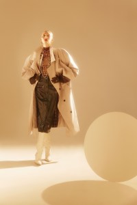 Y/Project’s cotton, polyester and nylon trenchcoat over Alexander Wang’s tulle bodysuit and Givenchy’s lamb leather skirt. Fendi boots and earrings; Chanel necklaces; Marc Jacobs gloves; APC ring; Lagos ring.